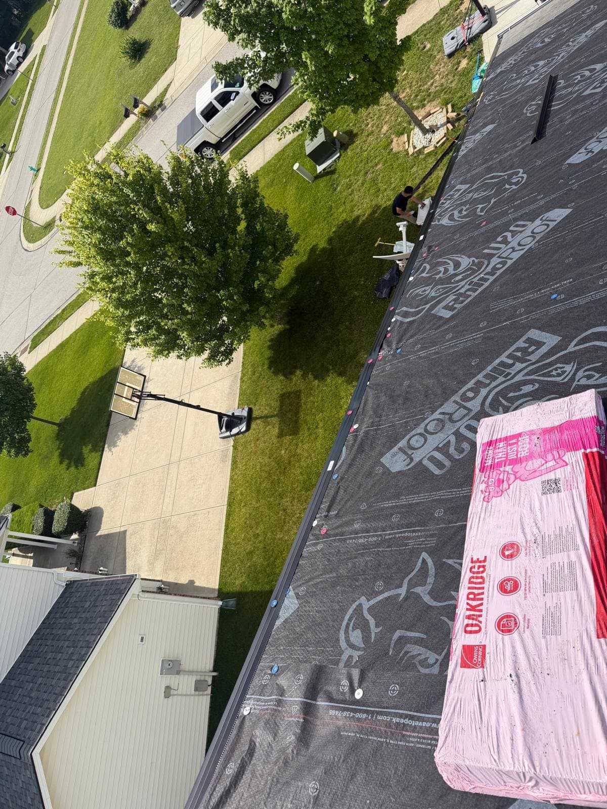 Owens Corning Oakridge architectural shingle bundles staged on the underlayment ready to install
