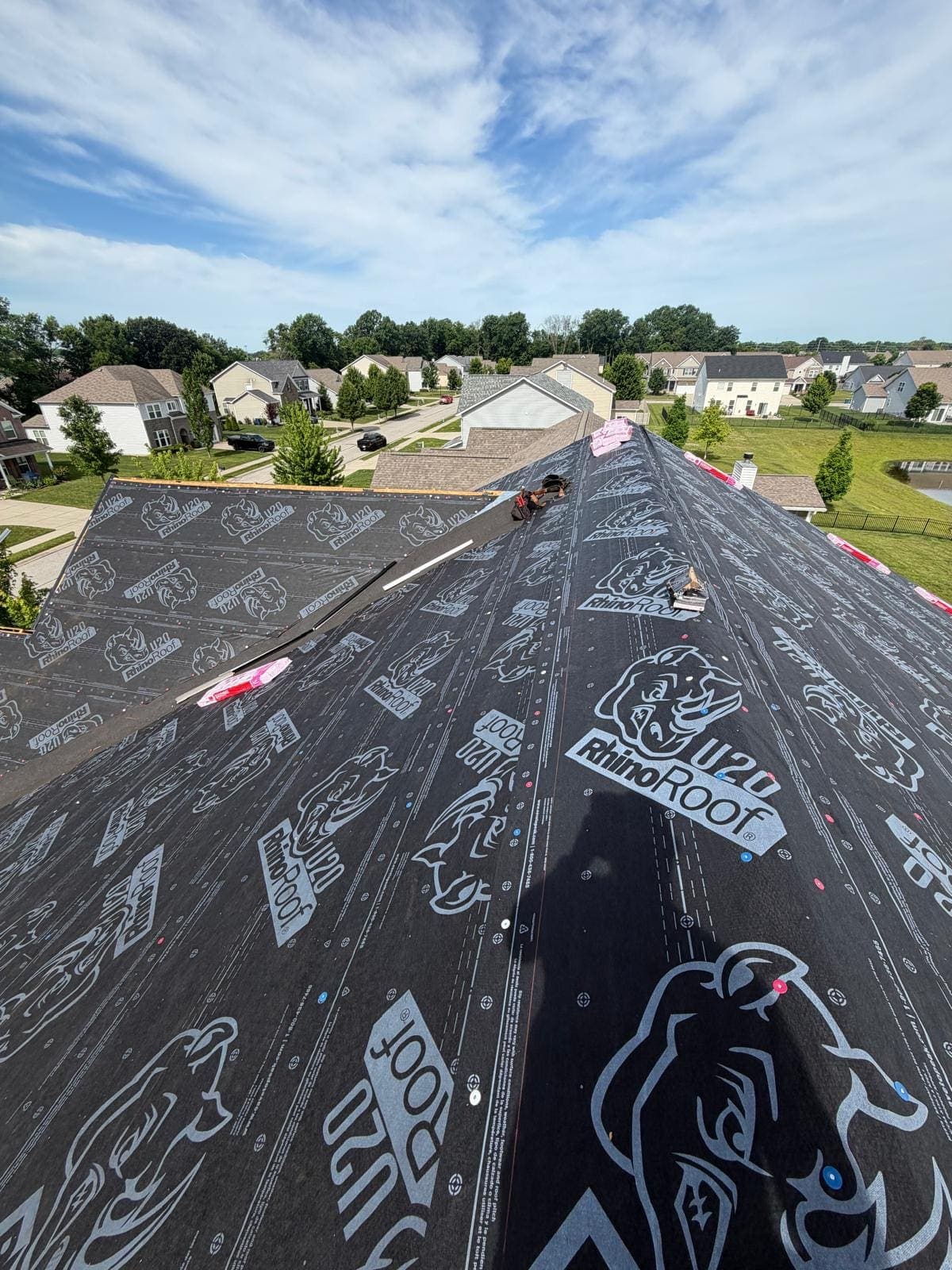 Roof slope with synthetic underlayment installed, overlooking a neighborhood pond in West Haven, Avon
