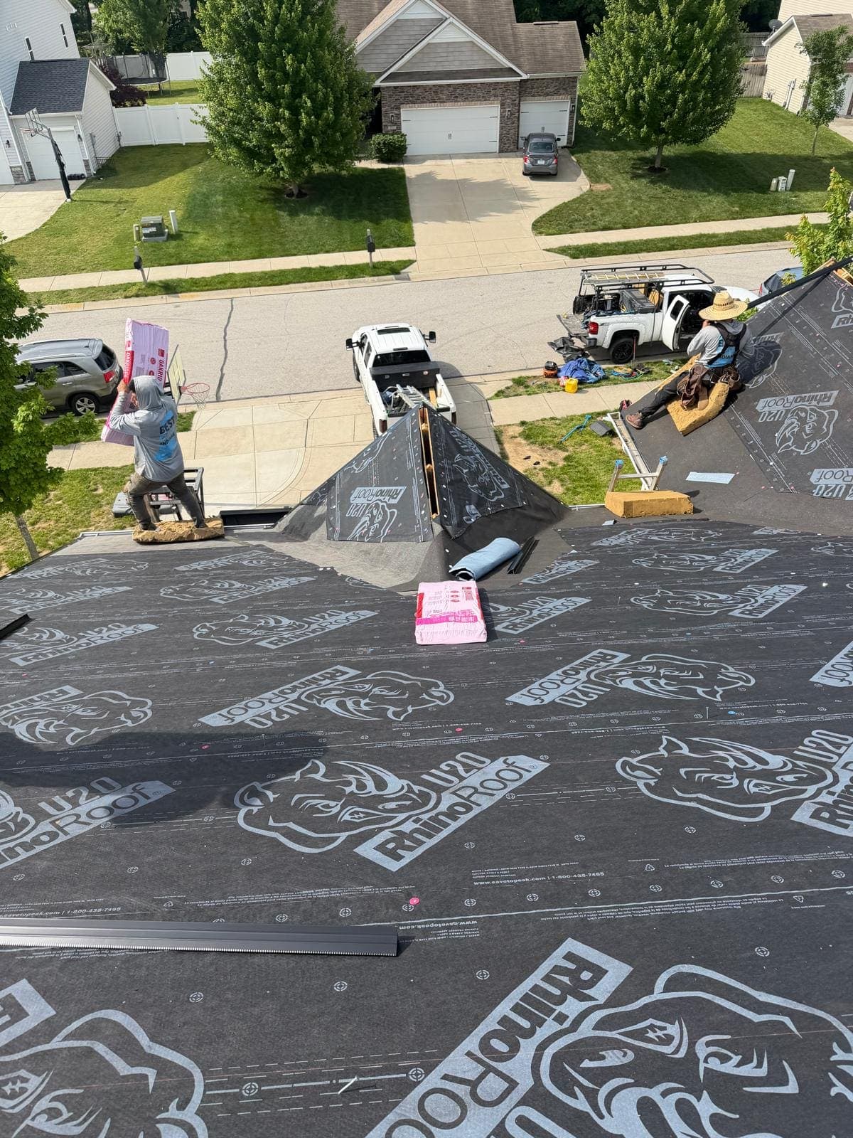 Full roof slope covered in synthetic underlayment with the Avon neighborhood visible below